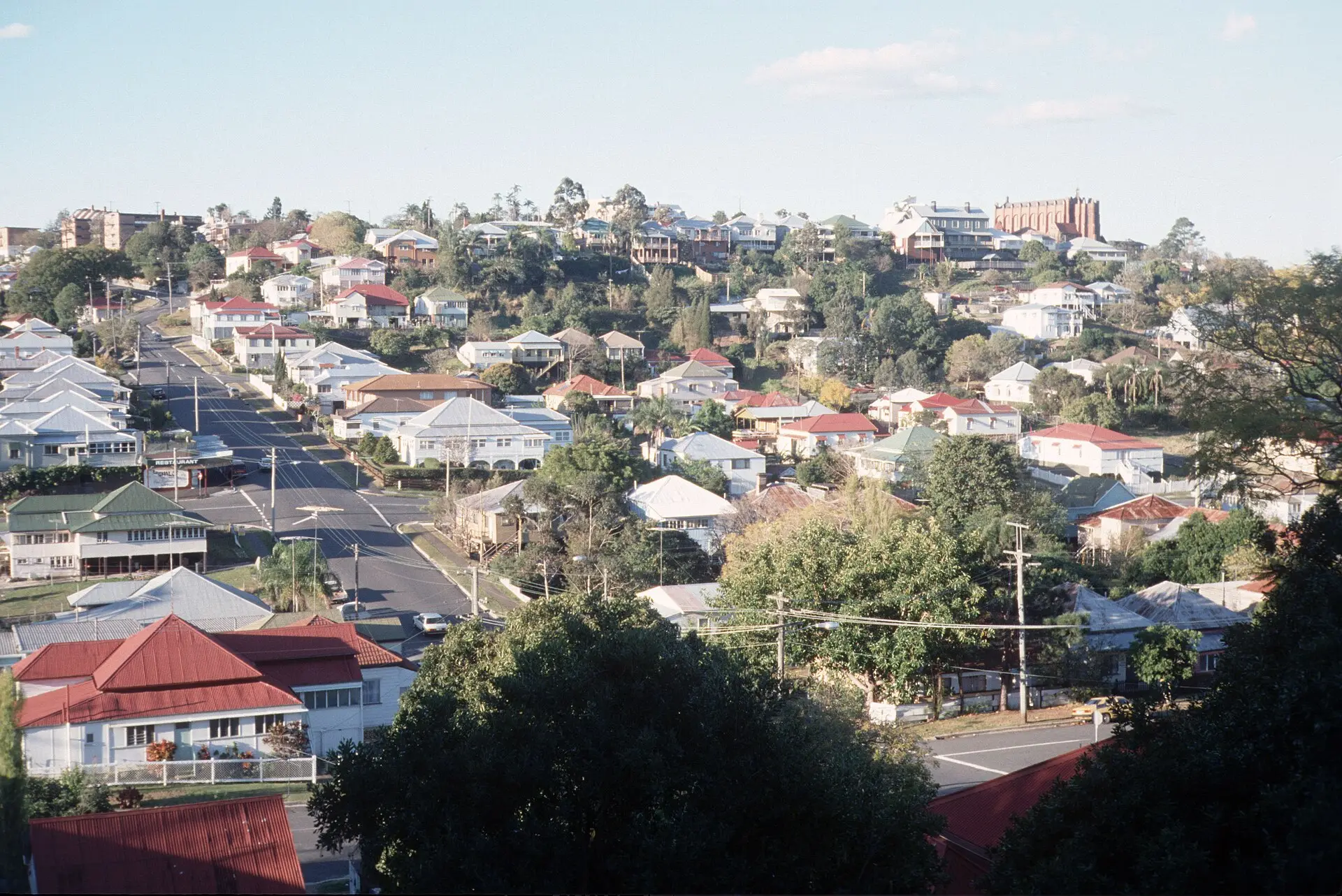Hillside Brisbane suburb of detached homes with red and white roofs