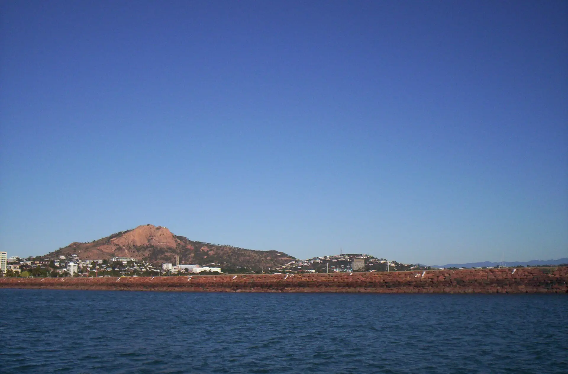 Castle Hill rising above Townsville seen across the water from the breakwater