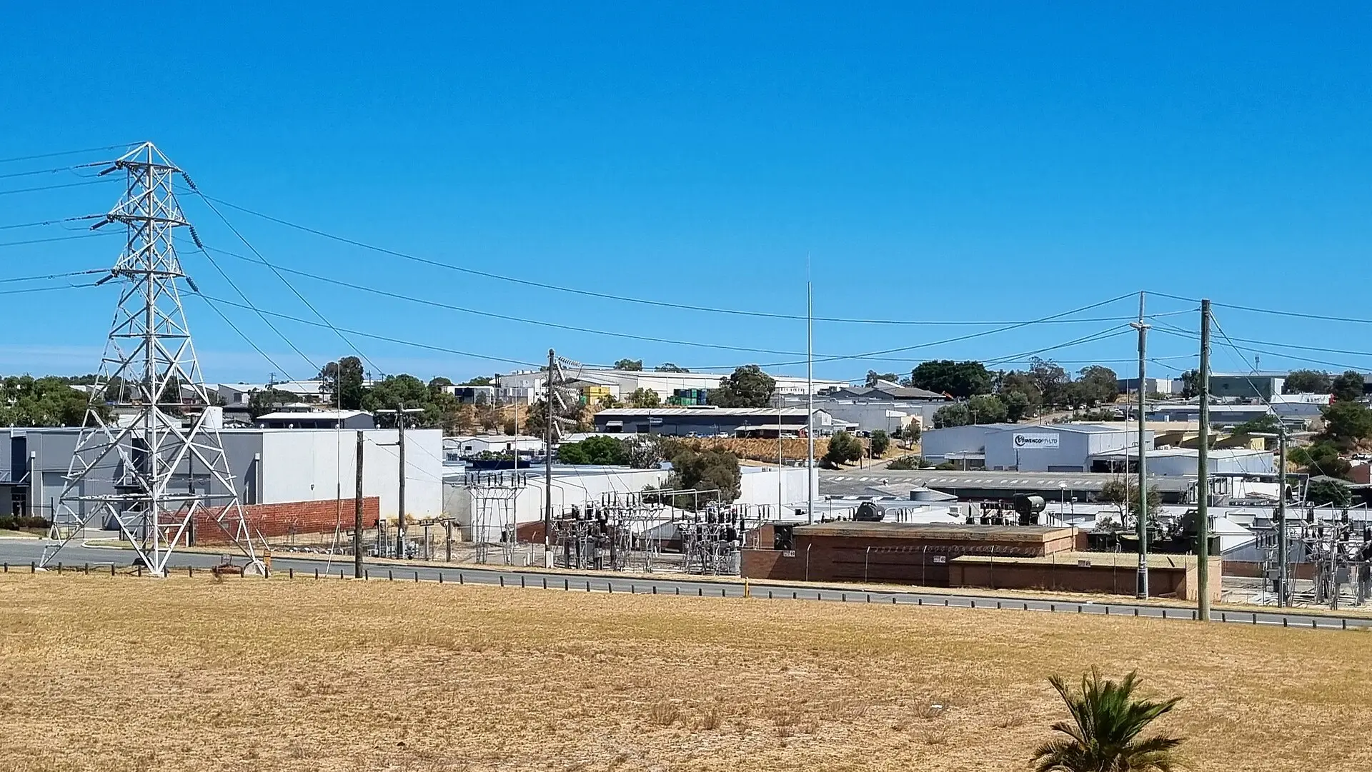 Industrial estate of warehouses and factory units beside transmission lines